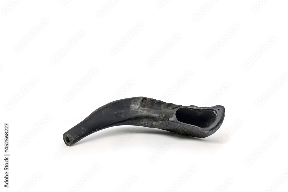 Obraz premium Shofar ( horn ) on a white background with space for text. A rams horn used to blow sounds on the Jewish new year Rosh Ha Shana
