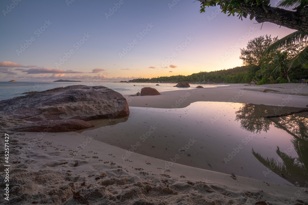 sunset at tropical beach anse lazio on praslin, seychelles