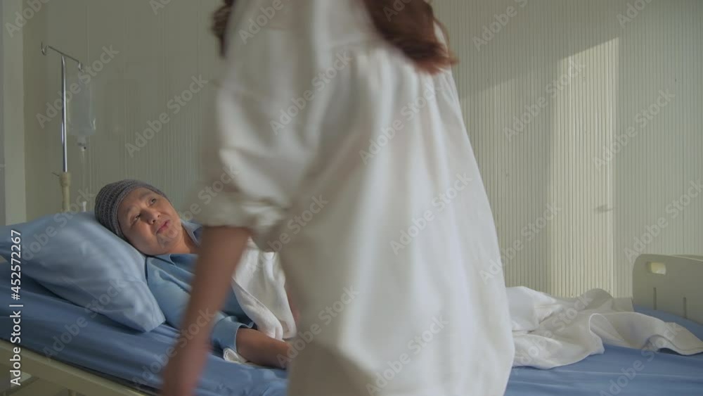 Medical concept of 4k Resolution. The daughter is coming to visit her mother who is being treated in the hospital. Medical concept of 4k Resolution. The daughter is coming to visit her mother who is being treated in the hospital.