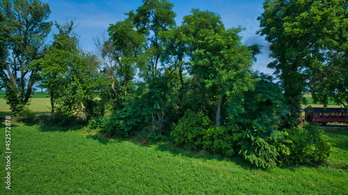 Foto Aerial View of Thomas the Tank Engine Approaching Thru Trees and Farmlands Pulli