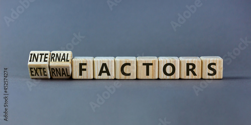 External or internal factors symbol. Turned wooden cubes and changed words external factors to internal factors. Beautiful grey background, copy space. Business, internal or external factors concept. photo