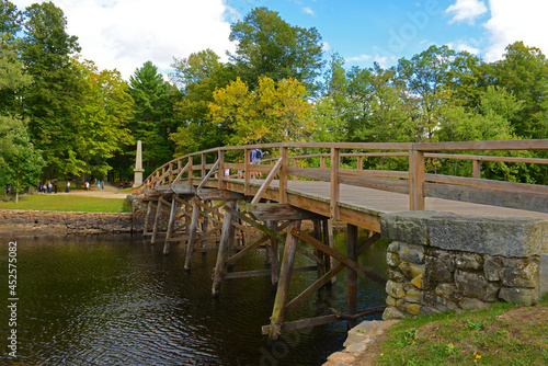 Old North Bridge and Memorial obelisk in Minute Man National Historical Park, Concord, Massachusetts MA, USA. photo