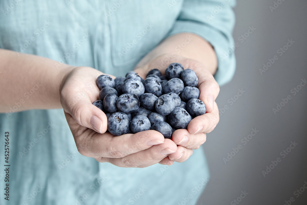 A handful of blueberries, blue berries in female hands A handful of blueberries, blue berries in female hands