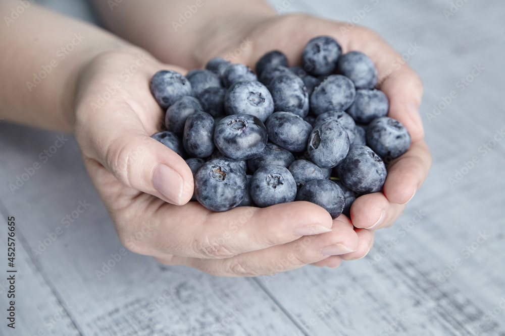 A handful of blueberries on wooden background