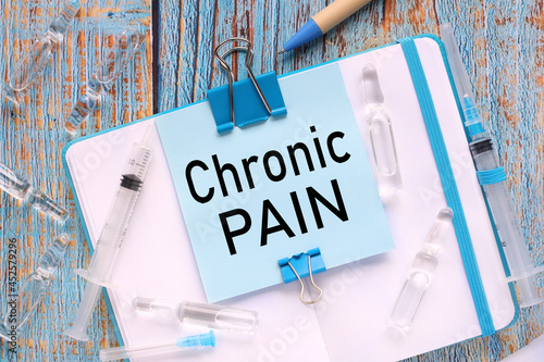 Foto Chronic Pain, the sticker is attached to the notebook with a clerical clip