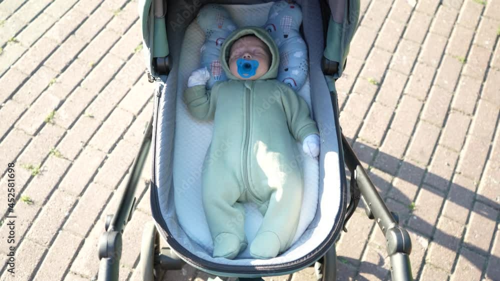 Baby lying in the pram on walk Baby lying in the pram on walk