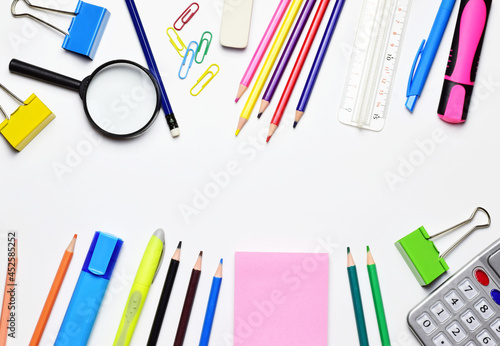 Back to school, variety of material. Central area for copy space, white background.