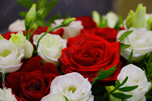 Out of focus  blurry background. Bouquet of red white roses.