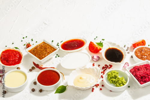 Fototapeta Naklejka Na Ścianę i Meble -  Set of different sauces - ketchup, mayonnaise, barbecue, soy, chutney, wasabi, adjika, horseradish