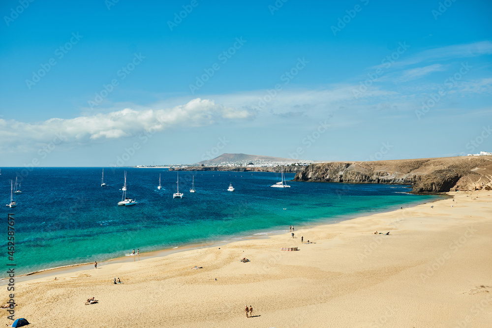 Beach with sailboats in the background Beach with sailboats in the background