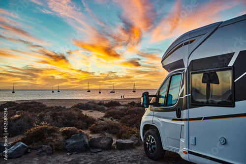 Caravan parked on seashore at sundown photo