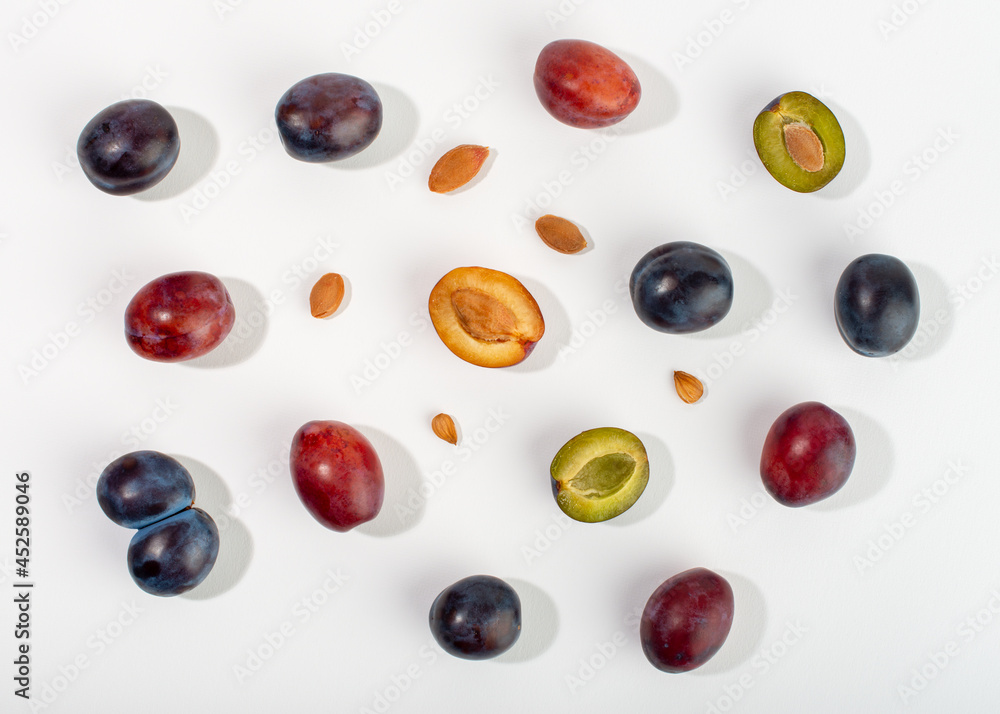 Plum fruits and kernels composition on white background. Plum fruits and kernels composition on white background.