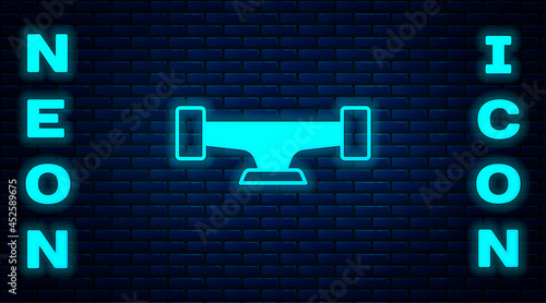 Glowing neon Skateboard wheel icon isolated on brick wall background. Skateboard suspension. Skate wheel. Vector