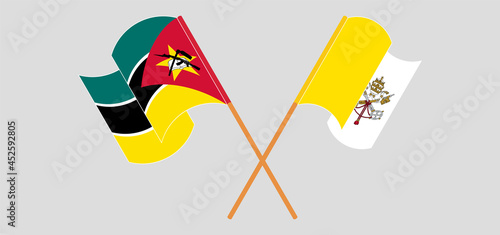 Crossed and waving flags of Mozambique and Vatican