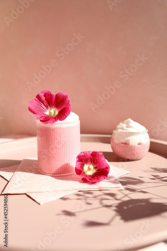Pinkish Paradise Strawberry Pudding with Pink Flowers on the Tray Shadow Creeping into the Scene Whipped Cream