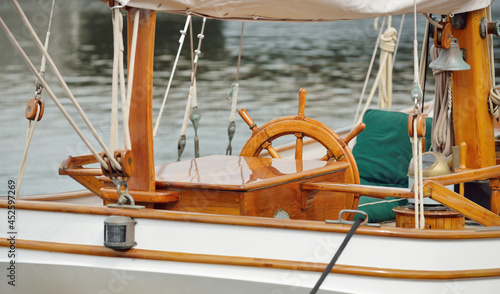 Expensive retro sailing boat (ketch) moored to a pier in a new yacht marina. Wooden teak deck, elegant details. Transportation, nautical vessel, vacations, tourism, cruising, regatta, recreation