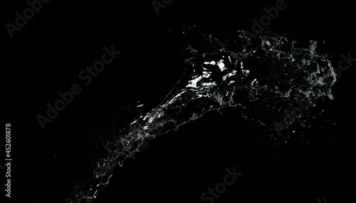 long stream of fresh transparent water isolated on black background. Splash and splash