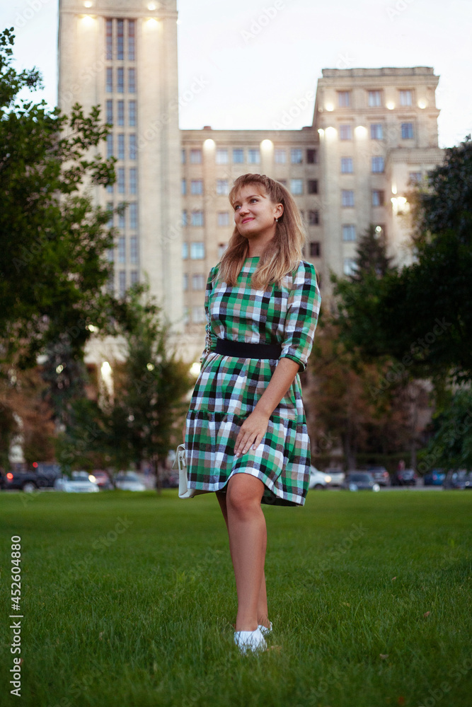 Happy woman in summer city in short dress