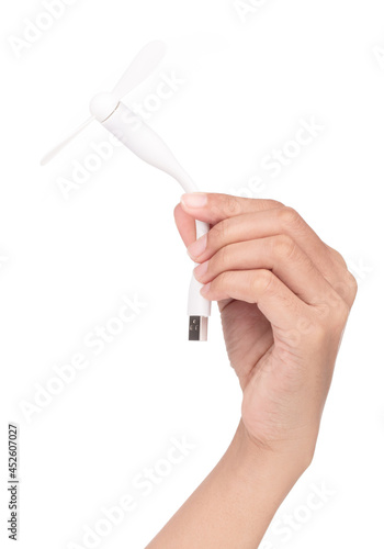 Hand holding A portable usb fan connected to power bank isolated on white background.