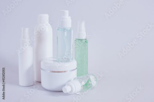 Composition of different cosmetic bottles mock-up on gray background