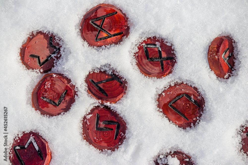 Scandinavian runes carved from wood lying in the snow Stock Photo ...