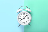 Stylish alarm clock on color background