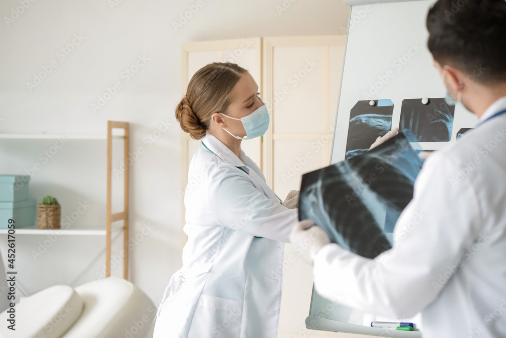 Fototapeta premium Young doctors with x-ray scan in clinic