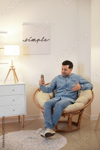 Young man video chatting at...