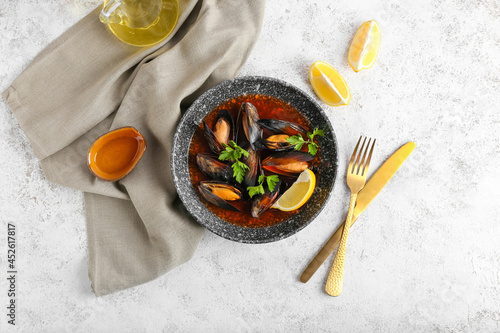 Plate with tasty Mussels Marinara on light background photo