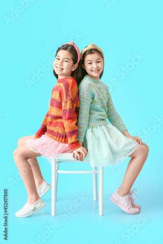 Cute little sisters sitting...
