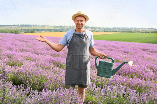 Farmer with watering can in...