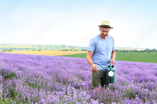 Farmer with watering can in...