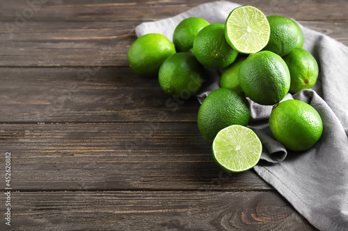 Tasty limes on wooden background