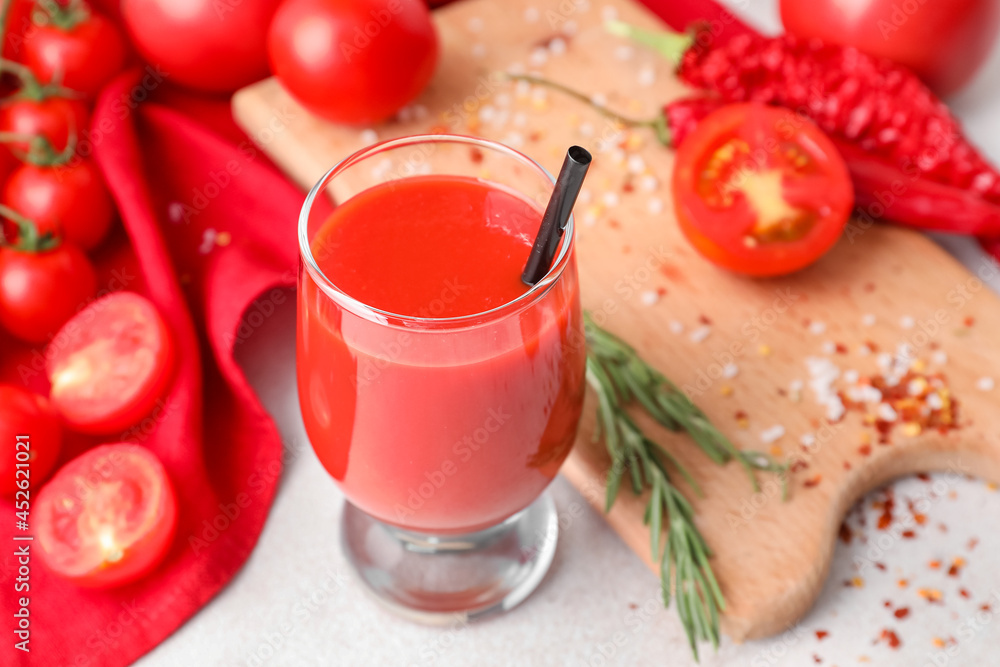 Glass of tasty tomato juice on light background Glass of tasty tomato juice on light background