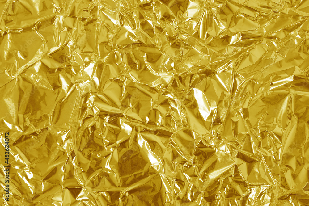 Gold foil leaf shiny texture, abstract yellow wrapping paper for background  and design art work. Stock Photo