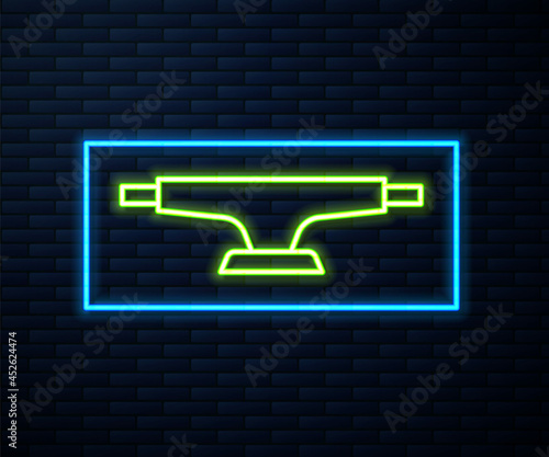 Glowing neon line Skateboard wheel icon isolated on brick wall background. Skateboard suspension. Skate wheel. Vector