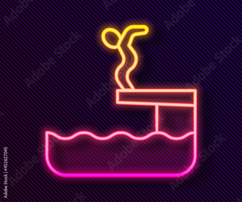 Glowing neon line Swimmer diving into pool icon isolated on black background. Vector