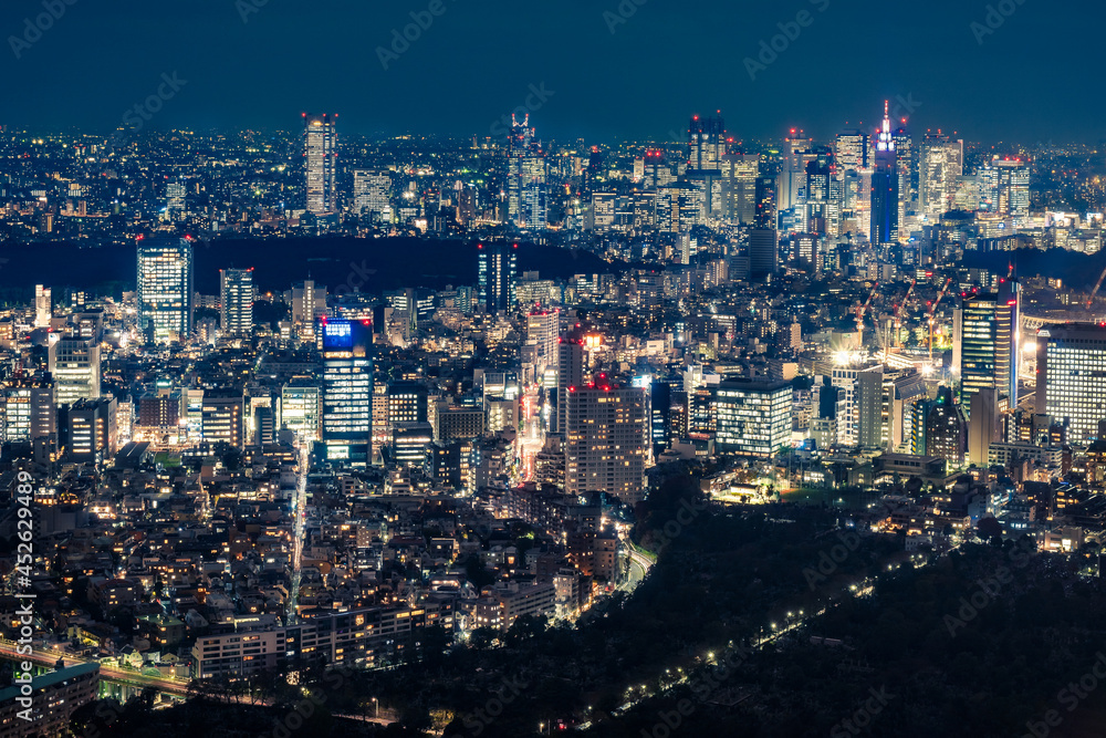 View from above the famous Mori Tower Skydeck of Tokyo metropolis at night with the partial view of the Olympic Stadium when under construction in 2018, Japan.