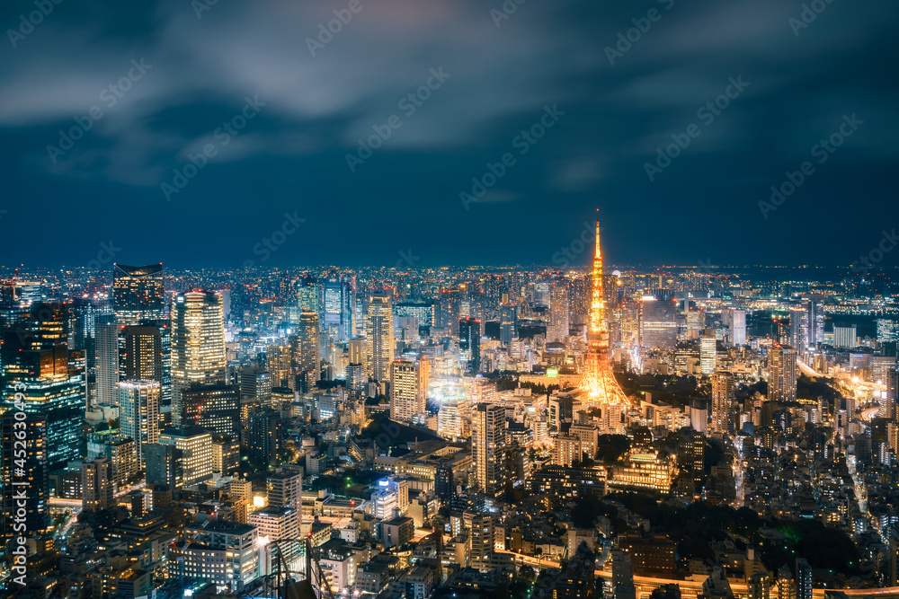 Long exposure Panoramic View from above of modern Tokyo Metropolis illuminated at night with Tokyo Tower and light trails on the streets below in Tokyo, Japan.