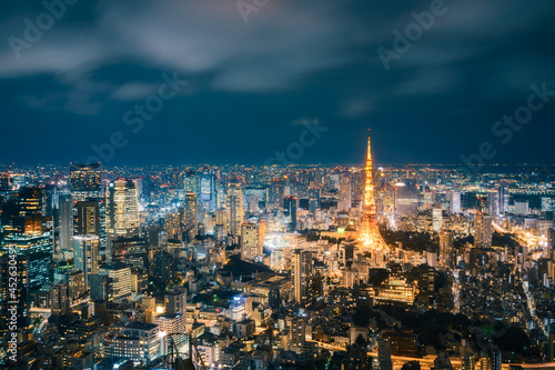 Long exposure Panoramic View from above of modern Tokyo Metropolis illuminated at night with Tokyo Tower and light trails on the streets below in Tokyo, Japan.