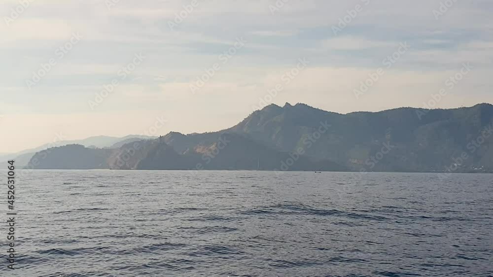 Looking at Rei Jesus Statue in the distance, early morning sunlight, travel to remote tropical island from capital Dili, Timor Leste, Southeast Asia Looking at Rei Jesus Statue in the distance, early morning sunlight, travel to remote tropical island from capital Dili, Timor Leste, Southeast Asia