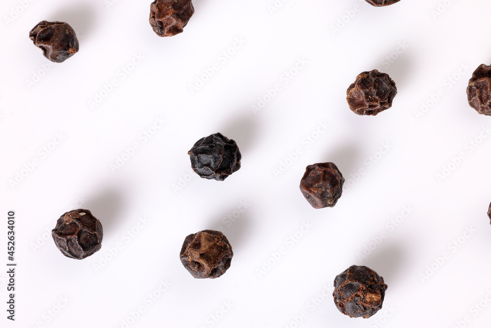 whole black pepper corn closeup macro on white background whole black pepper corn closeup macro on white background