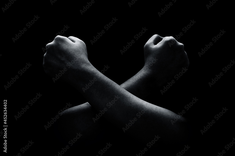 Fototapeta premium Hands crossed isolated on black background