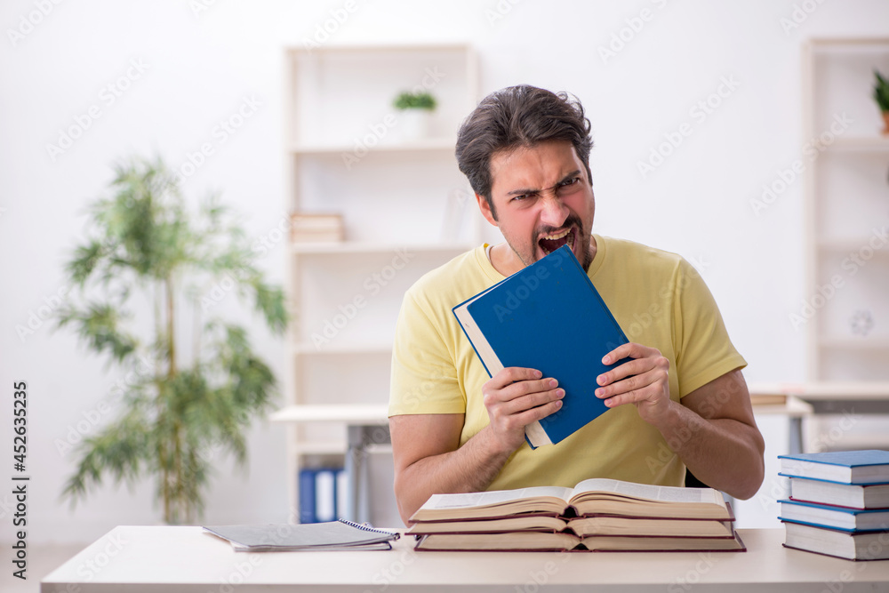 Young male student preparing for exams in the classroom Young male student preparing for exams in the classroom