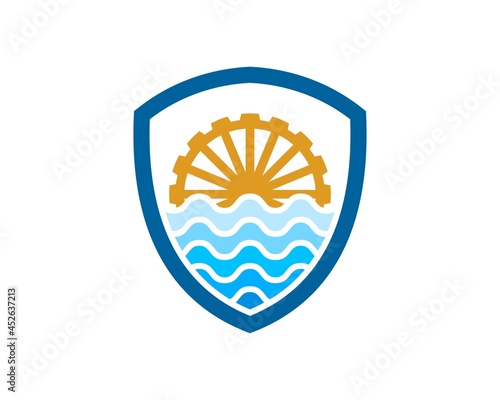 Shield with abstract wave and water mill inside