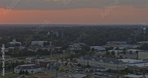 Tupelo Mississippi Aerial v1 circular pan shot showing townscape and radio transmission tower in close distance with glowing sunset on horizon - Shot with Inspire 2, X7 camera - August 2020 photo
