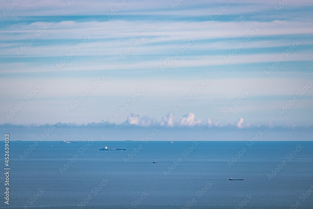 Cargo container ship on ocean horizon far away Cargo container ship on ocean horizon far away