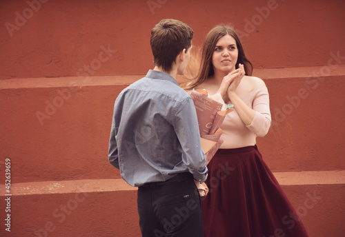 Handsome husband giving bouquet to wife