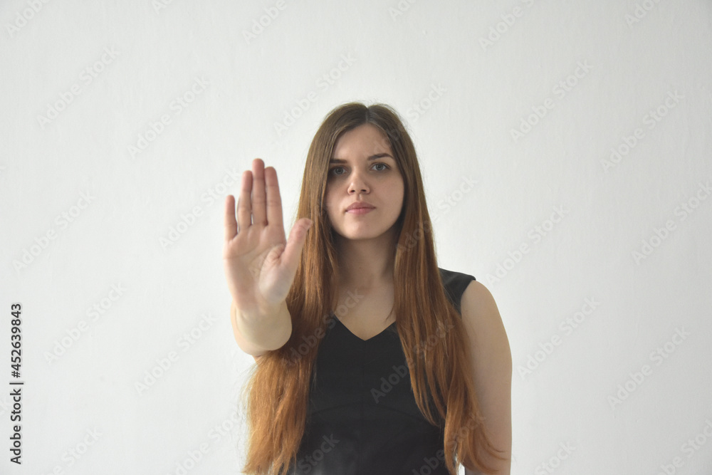 Serious woman outstretching hand on white background Serious woman outstretching hand on white background