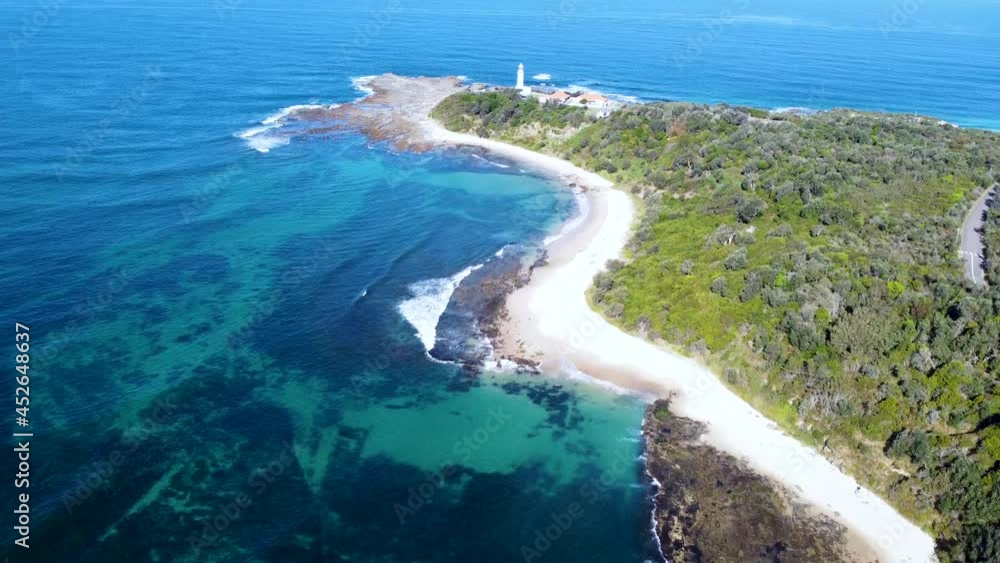 Drone aerial landscape shot of lighthouse crystal clear reef and ocean beach Norah Head Central Coast tourism NSW Australia 4K Drone aerial landscape shot of lighthouse crystal clear reef and ocean beach Norah Head Central Coast tourism NSW Australia 4K